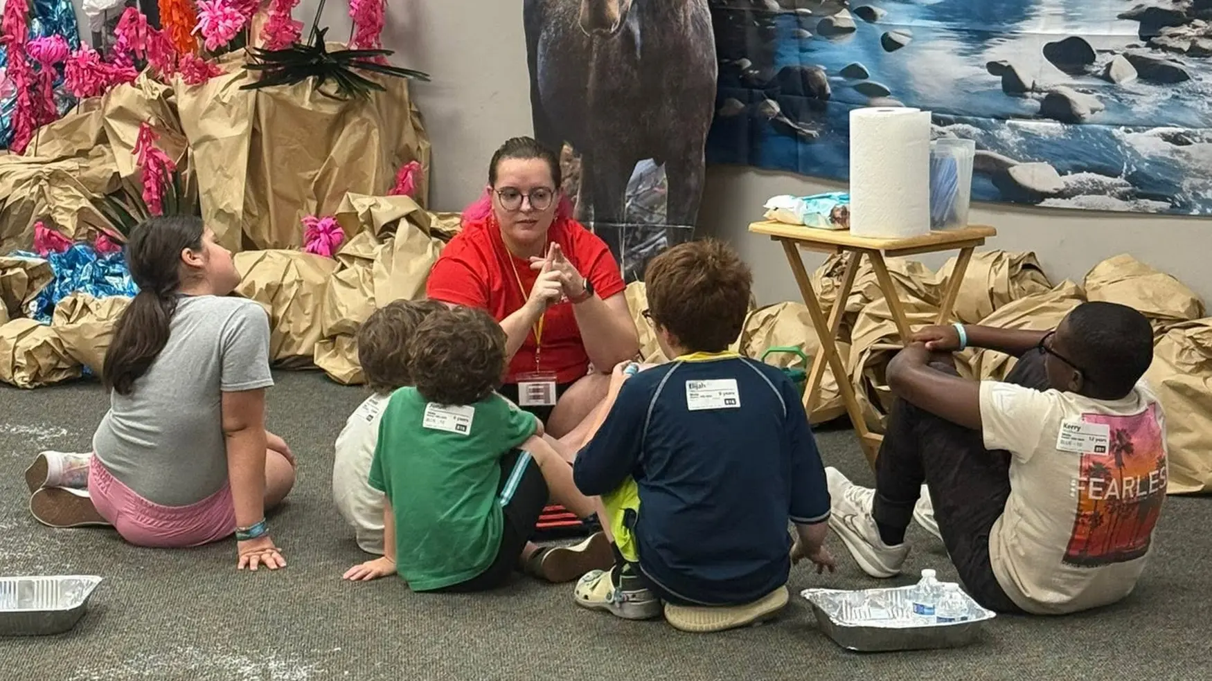 Children gathered around a teacher during a kids ministry lesson